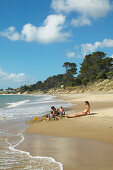 Sandcastle, girl playing on Opononi beach, Hokianga Harbour, Northland, North Island, New Zealand