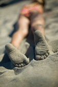 Girl's feet on sand, Spiekeroog island, East Frisian Island, Lower Saxony, Germany