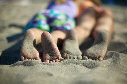 Girl's feet on sand, Spiekeroog island, East Frisian Island, Lower Saxony, Germany