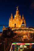 El Sagrat Cor, church, and carousel of the amusement park, Tibidabo, Barcelona, Catalonia, Spain
