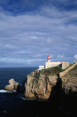 Lighthouse on rocky cliff, Cabo de Sao Vicente, Algarve, Portugal