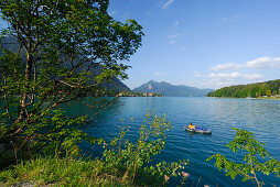 Lake Walchensee with woman in rubber dinghy, village of Walchensee and Jochberg in background, Upper Bavaria, Bavaria, Germany