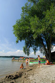 sandy beach at lake Simssee with family with four children and kayak, Chiemgau, Upper Bavaria, Bavaria, Germany