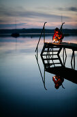 Boy on jetty at Lake Woerthsee, Walchstadt, Bavaria, Germany, MR