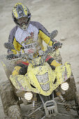 Man driving Suzuki Quad through mud, Test Grounds, Suzuki Offroad Camp, Valencia, Spain
