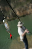 Man fishing at a reservoir, Bavaria, Germany