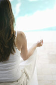 Woman practising yoga near a pool, Styria, Austria