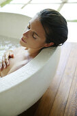 Mid adult woman relaxing in bathtub, Styria, Austria