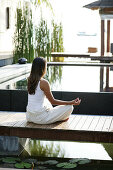 Woman meditating by a pool, Spa, Relaxation, Wellness