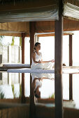 Woman meditating by a pool, Reflection in the water, Relaxation, Wellness, Health
