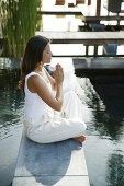 Woman meditating at the edge of a pool, Spa, Wellness, Relaxation, Health