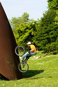 Trial biker on metal sculpture, Linz