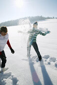 Two women snowball fighting, Styria, Austria