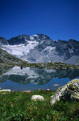 Reflection of Cima di Cantone on lake, Bergell, Grisons, Switzerland