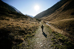 Child hiking in Knuttenbachtal Valley near Brunico, Alto Adige, Italy