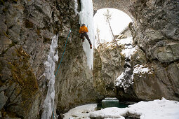 Man ice climbing in a gorge, Pontresina, Upper Engadin, Grisons, Switzerland