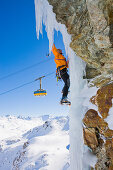 Man ice climbing at Corn Diavolezza (man-made icefall), Pontresina, Upper Engadin, Grisons, Switzerland