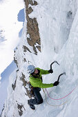 Teenager ice climbing at Corn Diavolezza (man-made icefall), Pontresina, Upper Engadin, Grisons, Switzerland