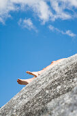 Naked person lying on Aletsch Glacier, Valais, Switzerland