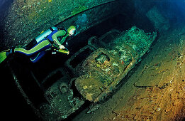 Scuba diver diving in the Umbria shipwreck, Military cars,  Sudan, Africa, Red Sea, Wingate Reef