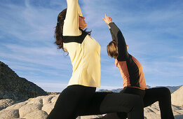Women practicing yoga at Snow Canyon State Park. Utah, USA