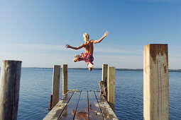  Action, Activity, Amusement, Back view, Bathing suit, Bathing suits, Blond, Blonds, Boy, Boys, Caucasian, Caucasians, Child, Children, Color, Colour, Contemporary, Daytime, Determination, Dive, Diving, Dock, Docks, Exterior, Fair-haired, Free, Freedom, F