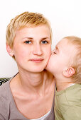 Boy kissing mother's cheek