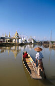 Monk on boat for alms. Inle Lake. Shan State. Myanmar.