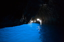 Rowing boat entering Blue Grotto, Capri, Campania, Italy