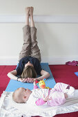 Mother in post natal yoga class with her baby