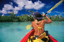 Woman kayaking in lagoon. Aitutaki. Cook Islands