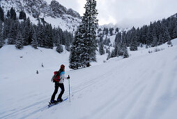 Female backcountry skier ascending Sulzspitze, Allgaeu Alps, Tyrol, Austria