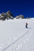 young woman ascending on ski track in Noppenkar, Allgaeu range, Allgaeu, Tyrol, Austria