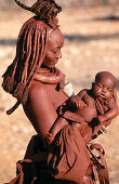 Himba wife with baby. Kaokoveld. Namibia.