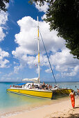 People entering a catamaran, Mullins Bay, Speightstown, Barbados, Caribbean