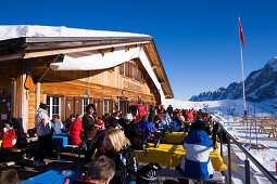 Tourists resting on terrace of mountain restaurant Schreckfeld, First, Grindelwald, Bernese Oberland, Canton of Bern, Switzerland