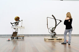 Young woman looking at sculptures in the Jean Tinguely Museum, Basel, Switzerland