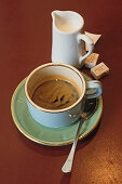 A cup of coffee and a jug of milk, Café au lait in a Cafe, Paris, France