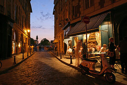 People outside a Bistro in the evening light, Place Dauphine, Isle de la Cité, Paris, France