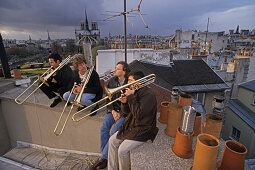 A group of musicians practicing on the roof, 1e Arrondissement Paris, France