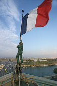 French tricolore, French flag being hoisted on the roof of the National Assembly, view across the Seine and Place de la Concorde, Paris, France