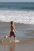 Seven years old child. Crystal Cove State Park. California. USA.