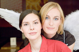 Angel, young woman with wings helping business woman in the office, Munich, Bavaria, Germany