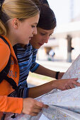 Two young women reading a map