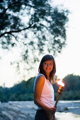 Young woman holding torch, Munich, Bavaria, Germany