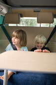 Two girls (2-4 years) sitting in a motorhome