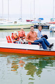 Family in a pedal boat on lake Ammersee, Bavaria, Germany