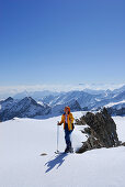 Female back-country skier ascending Lusener Spizte, Stubai Alps in background, Sellrain, Tyrol, Austria