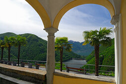 archway with view to reservoir of Verzasca and lake Lago Maggiore, Mergoscia, Ticino, Switzerland