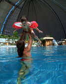 Mother and daughter playing in a pool, Tropical Islands Resort, Krausnick, Brandenburg, Germany